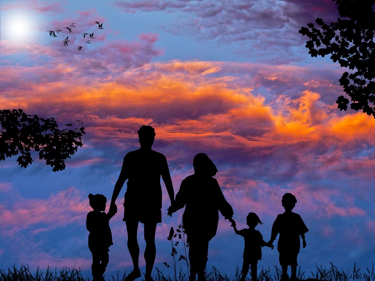 Parenting with Human Design - picture of parents and children in harmony silhouetted against a blue, purple and orange sky