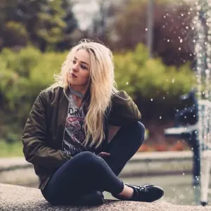 Waiting in Human Design - lady waiting by a fountain