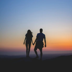 Relationship - couple walking at sunset